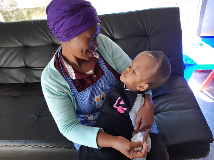 Ma Doris holding Smangi  |  Butterfly Palliative Home